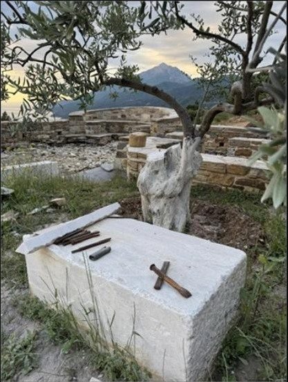 Stone cross among olive groves